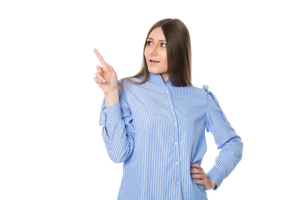 Surprised young woman in striped shirt points finger. — Stock Photo, Image