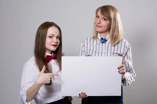 Two beautiful girls with a banner — Stock Photo, Image