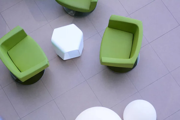 Top view of three green armchairs with a white table — Stock Photo, Image