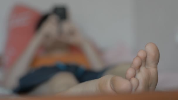 Close-up of a man's foot lying on a bed — Stock Video