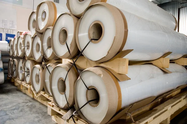 Large rolls of transparent polyethylene lie on a pallet. — Stock Photo, Image