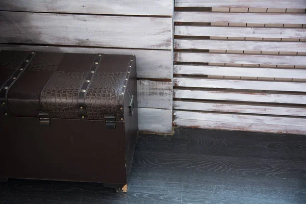 Leather old chest standing on the floor against — Stock Photo, Image