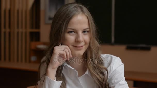 Portrait of young cute blonde, female student looking — Stock Video