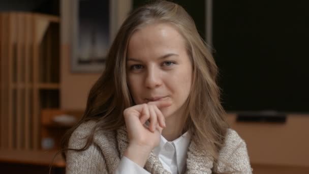 Portrait of young cute blonde, female student looking — Stock Video