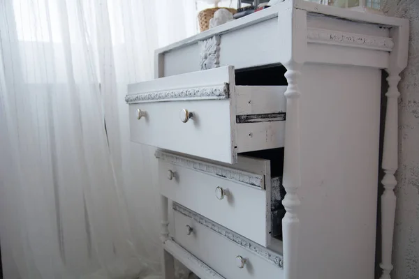 An old painted white ladies chest of drawers
