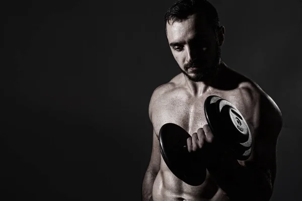 Young muscular man with dumbbells — Stock Photo, Image