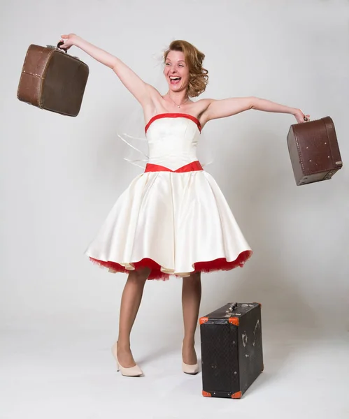 Cheerful bride with suitcases — Stock Photo, Image