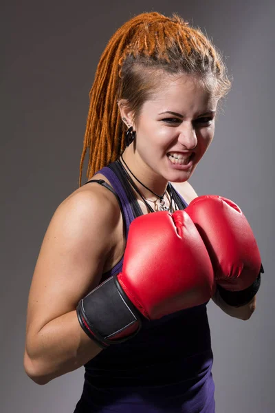 Young woman boxer with dreadlocks with clenched teeth — Stock Photo, Image