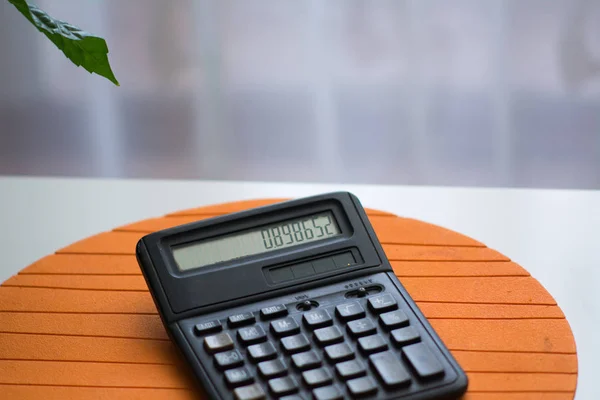 Black calculator on white table — Stock Photo, Image