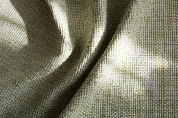 Folded green synthetic fabric. — Stock Photo, Image