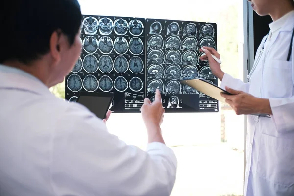 Education profession people and medicine concept close up of happy doctors with tablet and papers at seminar or hospital