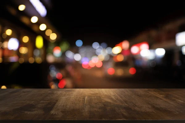 Empty dark wooden table in front of abstract blurred bokeh backg — Stock Photo, Image