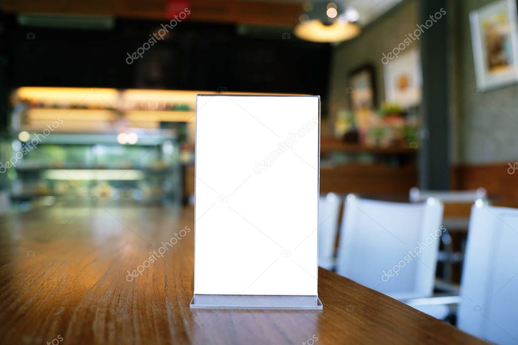 Mock up Menu frame standing on wood table in Bar restaurant cafe