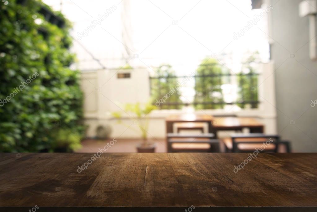 image of wooden table in front of abstract blurred background of