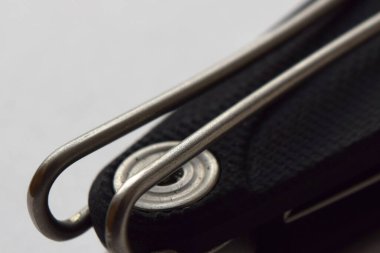 The butt of the folding knife with a clip and black plates made of anodized duralumin and G10