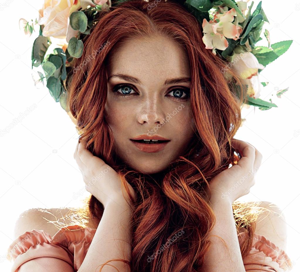 beautiful unusual girl with red hair in a wreath on the head