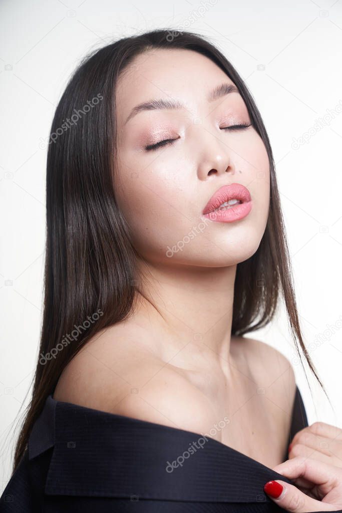 Portrait of a young beautiful Asian girl with her eyes closed. The concept of skin care facial, makeup                               