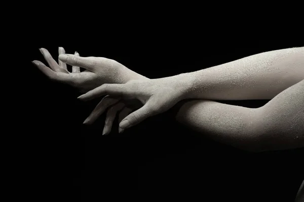 Hands of a living sculpture of a young woman