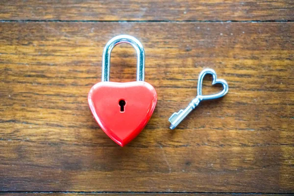 Ключевое красное сердце на деревянном столе, понятие любви и Валенти — стоковое фото