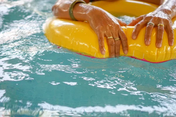 Swim ring floating on blue water with an airy wave reflection in