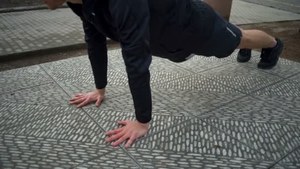 Man with healthy lifestyle doing plank in the city park closeup slow motion — Stock Video