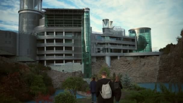 Unga turister gå mot en extraordinärt vacker byggnad slowmotion — Stockvideo