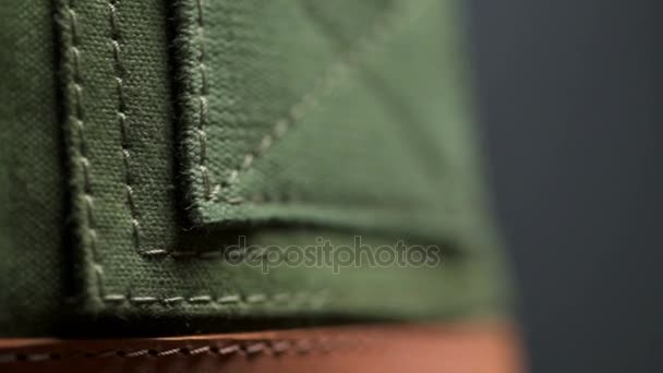 Pieces of green stitched thick cloth closeup macro — Stock Video