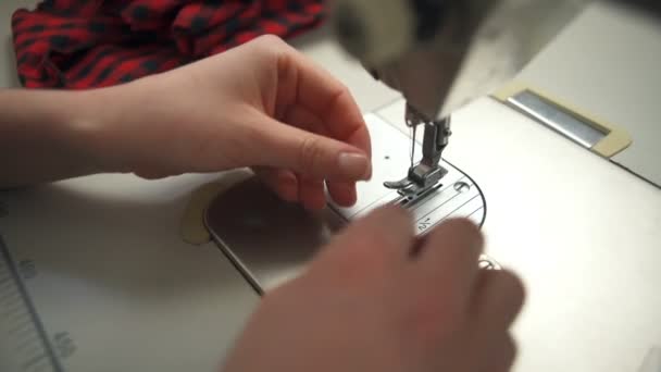 A young woman accurately threading a needle in the sewing machine — Stock Video