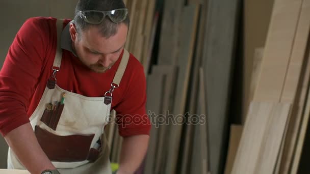 Carpenter lucida il bordo del tavolo con blocco abrasivo in primo piano in officina — Video Stock