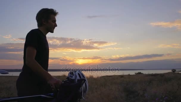 Cyklist gåtur med cykelhjelm felt dal daggry havet slowmotion hurtig – Stock-video