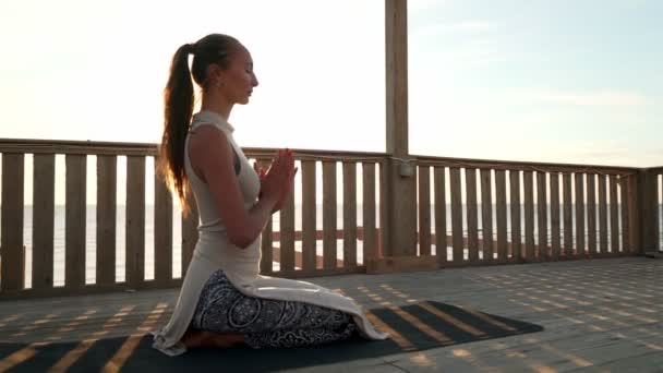Blank meisje meditatie op het dak in zonneschijn — Stockvideo