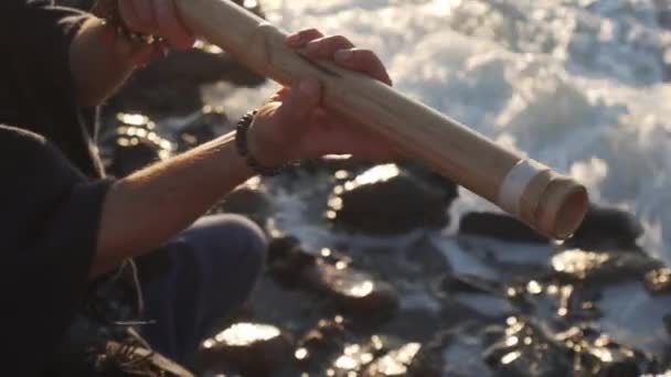 Close up uomo suonare su bansuri tradizionale strumento indiano in riva al mare — Video Stock