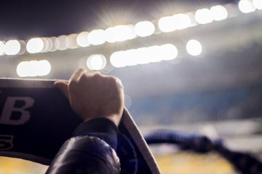futbol takımının bayrakları tutan stadyumda fanlar