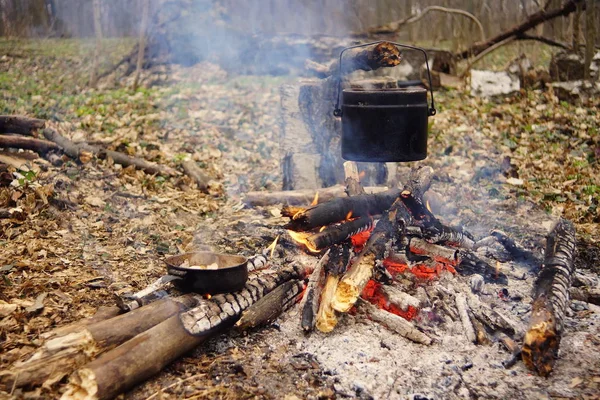 Preparing food on campfire in wild camping as