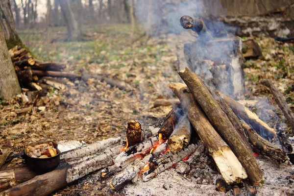 Preparing food on campfire in wild camping as