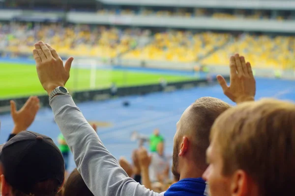 Football- soccer fans support their team and celebrate goal in full stadium with open air with nice sky.-blur picture. — Stock Photo, Image