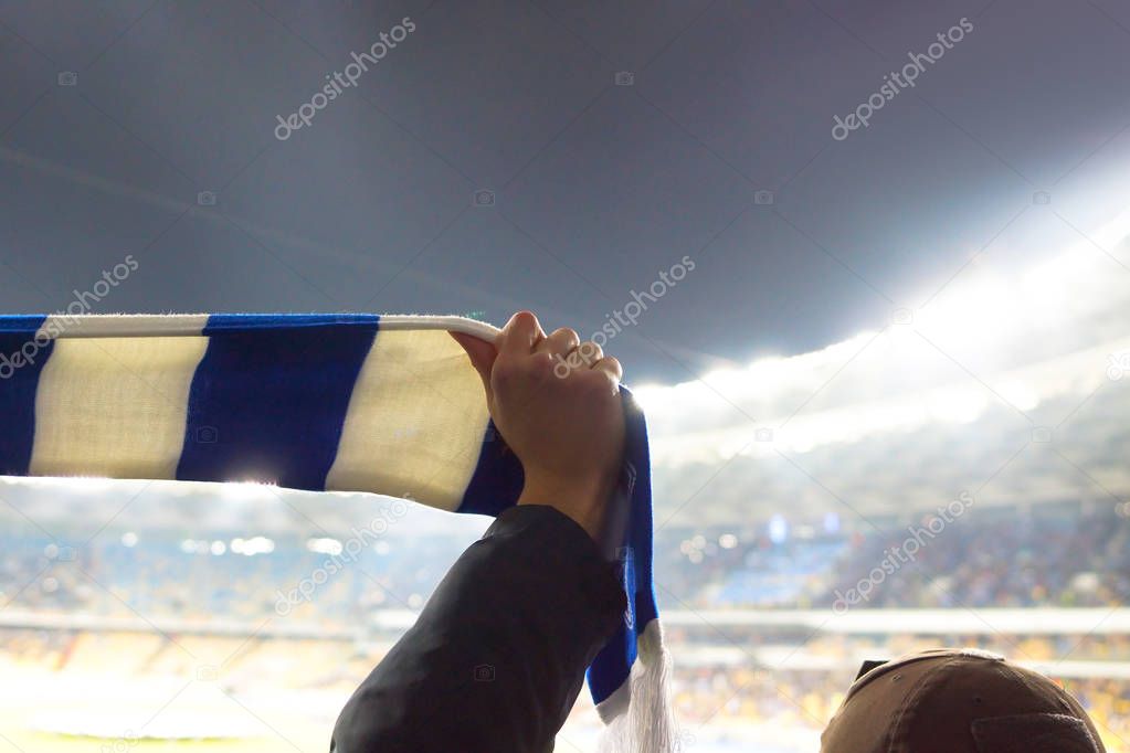 Football fans keep scarves with the color of their clubs