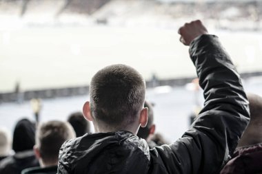 Taraftarlar, favori spor takımlarının başarısını kar yağarken profesyonel stadyumun tribünlerinde kutluyorlar..