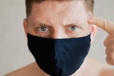 Tıbbi maskeli adam, öfkeli duyguların portresi..