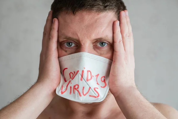 Man in a medical mask coughing, guy is ill, portrait, closeup