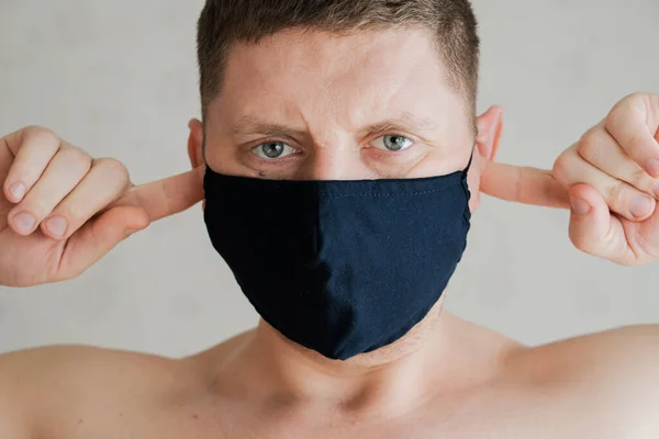 Guy in a medical mask, Portrait of angry emotions.