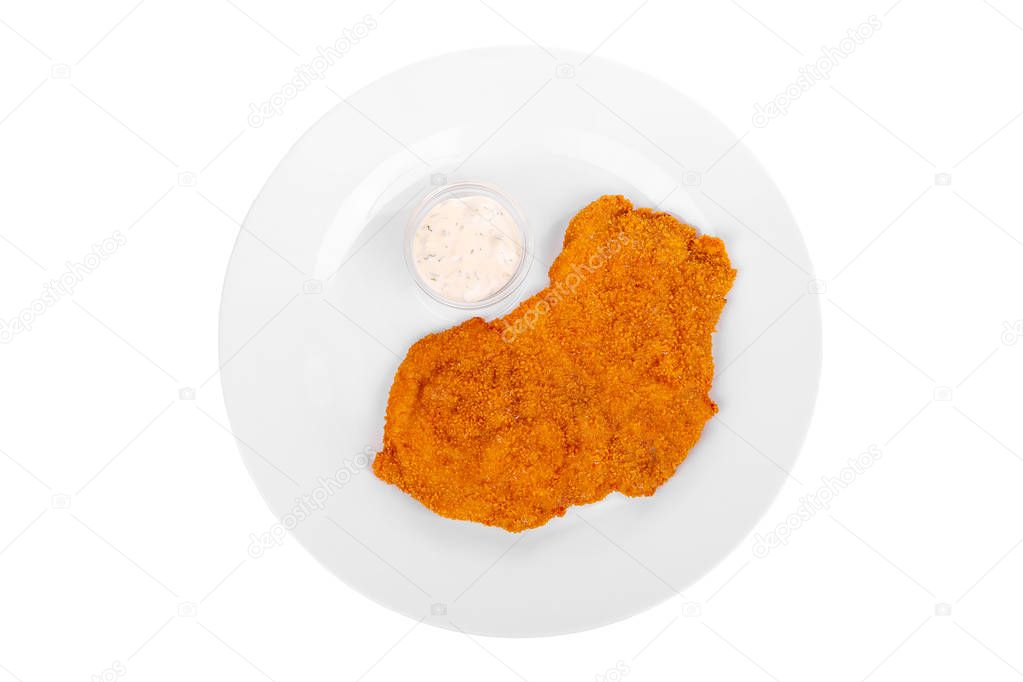 Schnitzel with white sauce on a plate isolated