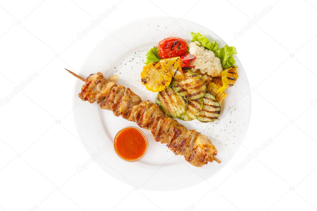 Shish kebab with sauce isolated with vegetables