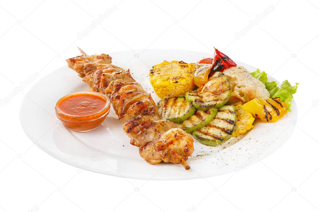 Shish kebab with sauce isolated with vegetables