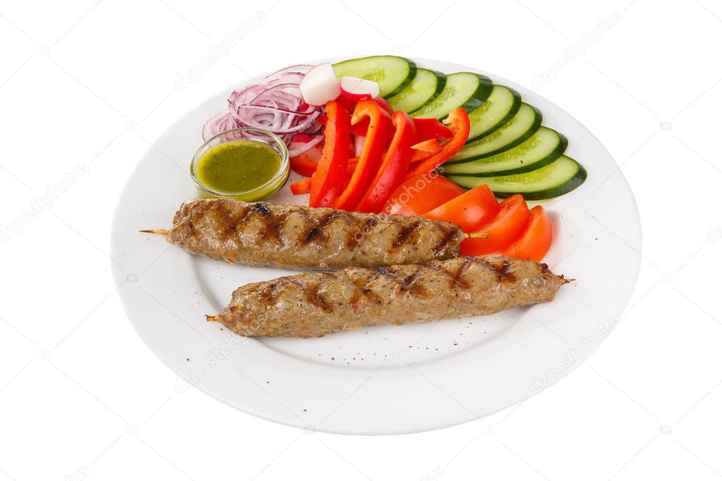 Kebab meat with sauce isolated with vegetables