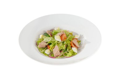 Caesar salad with tuna on plate white isolated