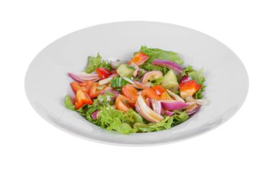 Vegetable salad with sauce on plate white isolated