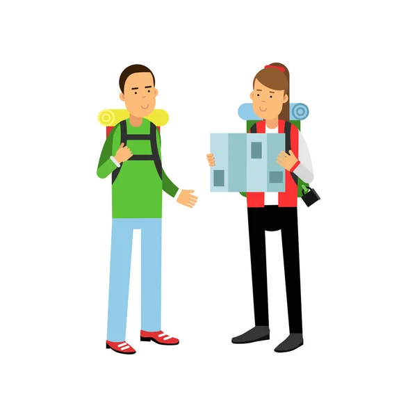 Young couple traveling with hiking backpacks on shoulders. Girl looking at map. Adventure and outdoor recreation concept