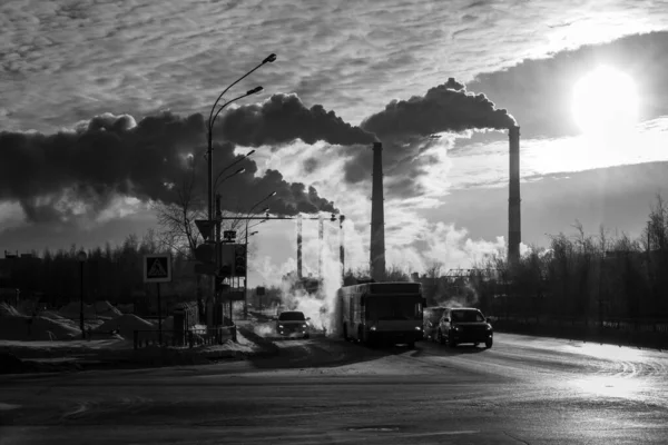 Machine the road pavement on the background of factory chimneys. The concept of environmental pollution environment. retro style vintage urban city. — ストック写真