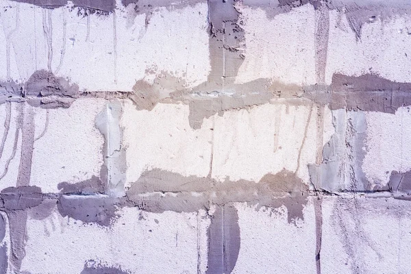 Close up of the white brick wall texture background and Traces of putty plaster construction of a new home — стоковое фото